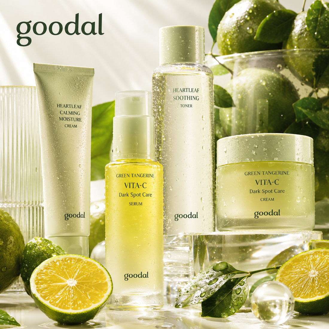 Goodal Korean skincare set with Green Tangerine Vita-C Dark Spot Care serum and cream, Heartleaf Calming Moisture Cream and Heartleaf Soothing Toner, surrounded by fresh green tangerines